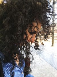 Woman standing on tree trunk