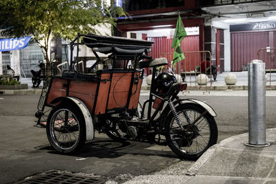 Bicycles parked on street against buildings