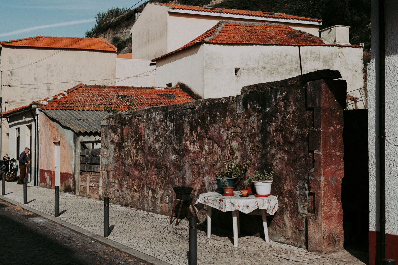 architecture, built structure, building exterior, building, old, no people, table, house, seat, residential district, day, wall, town, city, wall - building feature, food and drink, nature, outdoors, weathered, brick, alley