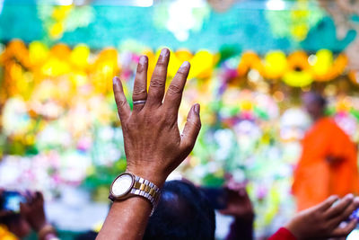 Close-up of hand holding hands against blurred background