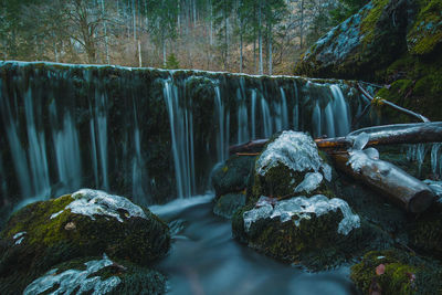 Water flowing through rocks in forest