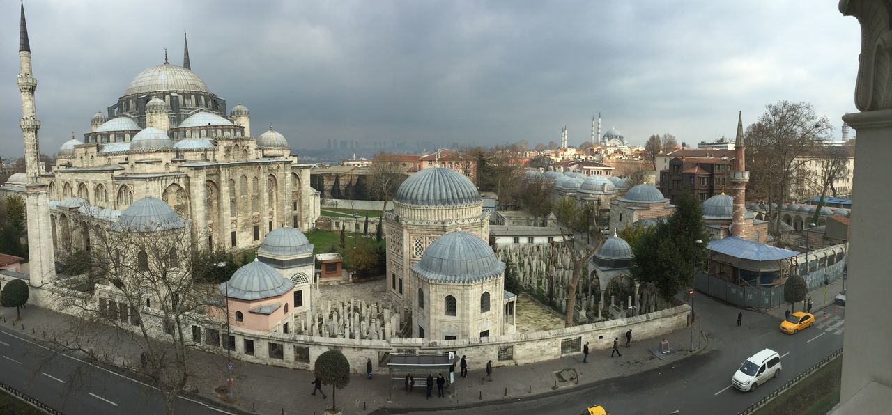 architecture, building exterior, built structure, transportation, sky, mode of transport, city, cloud - sky, car, nautical vessel, church, travel, place of worship, travel destinations, religion, land vehicle, famous place, water, dome