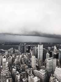 Aerial view of cityscape by sea against sky