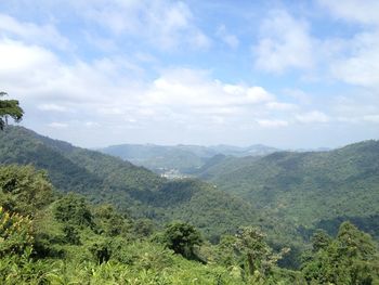 Scenic view of mountains against cloudy sky