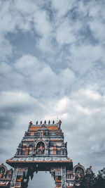 Low angle view of temple building against cloudy sky