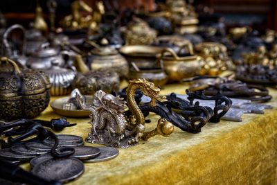 Close-up of figurines for sale on market stall