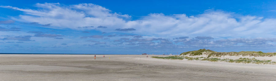 Scenic view of beach against blue sky