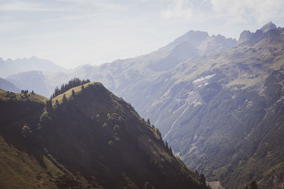 Scenic view of valley and mountains against sky