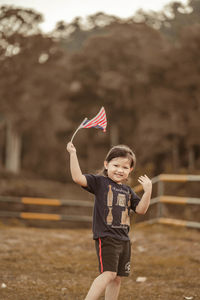 Cute girl with malaysia flag. independence day malaysia concept.