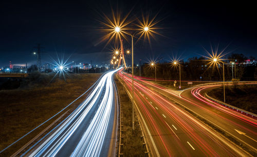 High angle view of light trails on road at night