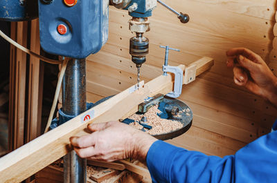 Drilling holes in wooden board. making wooden legs for easels. joinery work.