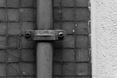 Close-up of pipe clamp mounted on wall