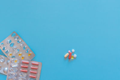 Close-up of multi colored candies against blue background