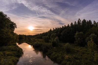 Scenic view of river against sky during sunset