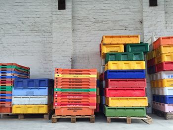 Stack of multi colored crates against wall