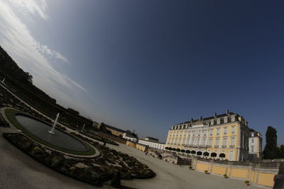 Panoramic view of road by buildings against sky