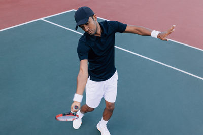 Rear view of man playing tennis