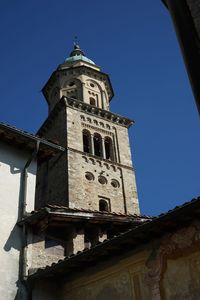 Low angle view of church tower against blue sky