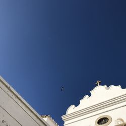 Low angle view of birds flying against sky