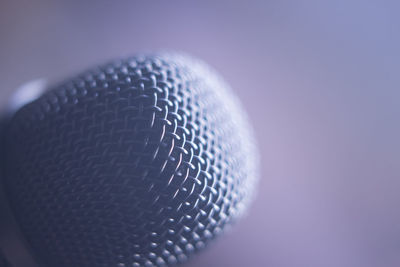 Close-up of electric fan against gray background