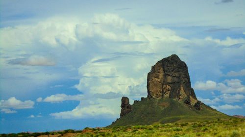 Scenic view of mountains against cloudy sky