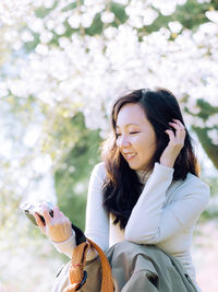 Young woman sitting on field