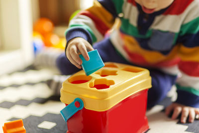 Close-up of boy playing with toy at home