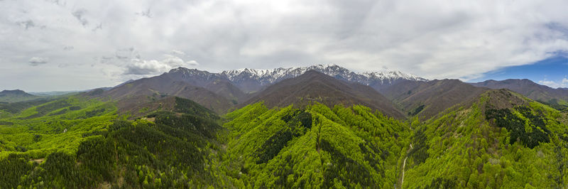 Panoramic view of land and mountains against sky