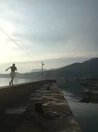 Silhouette of woman against sky