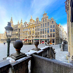 Buildings in city against cloudy sky