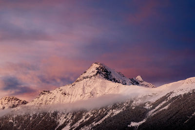 Scenic view of snowcapped mountains against sky during sunset