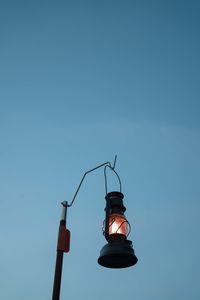 Low angle view of street light against blue sky