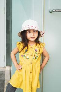 Portrait of beautiful little gorgeus lovely toddler girl in mustard summer look fashion dress, hat.
