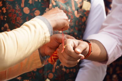 Midsection of couple holding hands