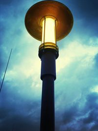 Low angle view of lighthouse against cloudy sky