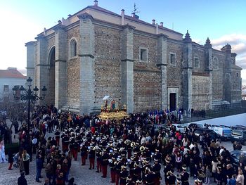 Crowd on street amidst buildings in city