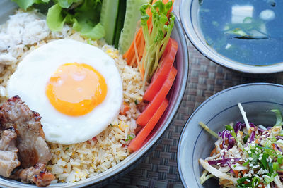 Kimchi fried rice with fried egg on top and chopsticks for eating, korean food