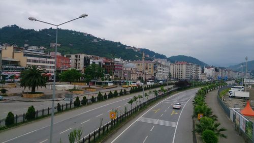 Road by city against sky