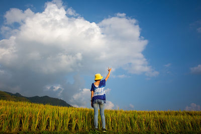 Man standing on field against sky