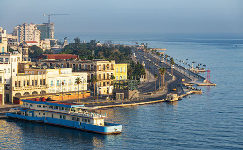 High angle view of buildings by sea against sky