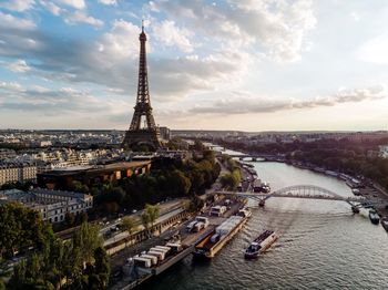 Aerial view of city against cloudy sky