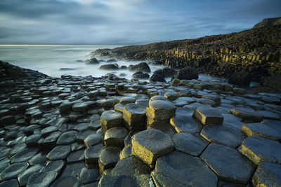 Rocks on beach against sky