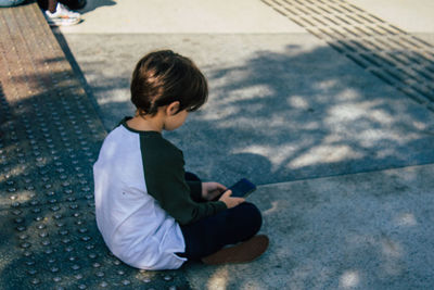 High angle view of boy sitting on floor