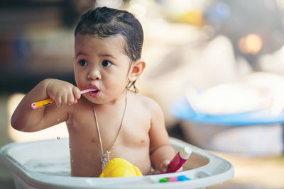 Dental hygiene. asian cute girl or kid brushing her teeth by toothbrush outdoor bathroom.