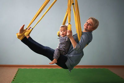 Low angle view of boy playing on slide at home