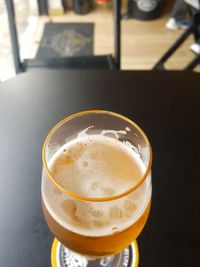 Close-up of beer glass on table