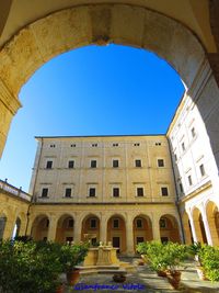 Low angle view of historical building against blue sky