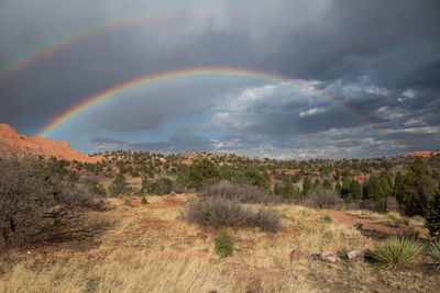 Scenic view of rainbow over mountain against sky