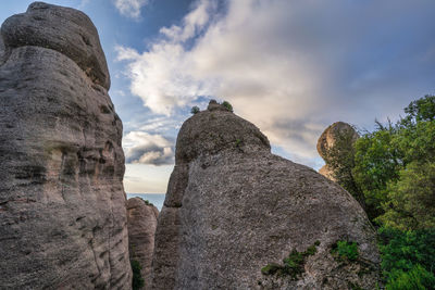 Low angle view of rock formations against sky