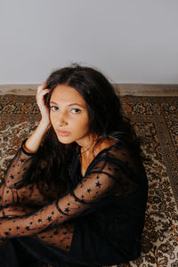 Portrait of young woman sitting outdoors